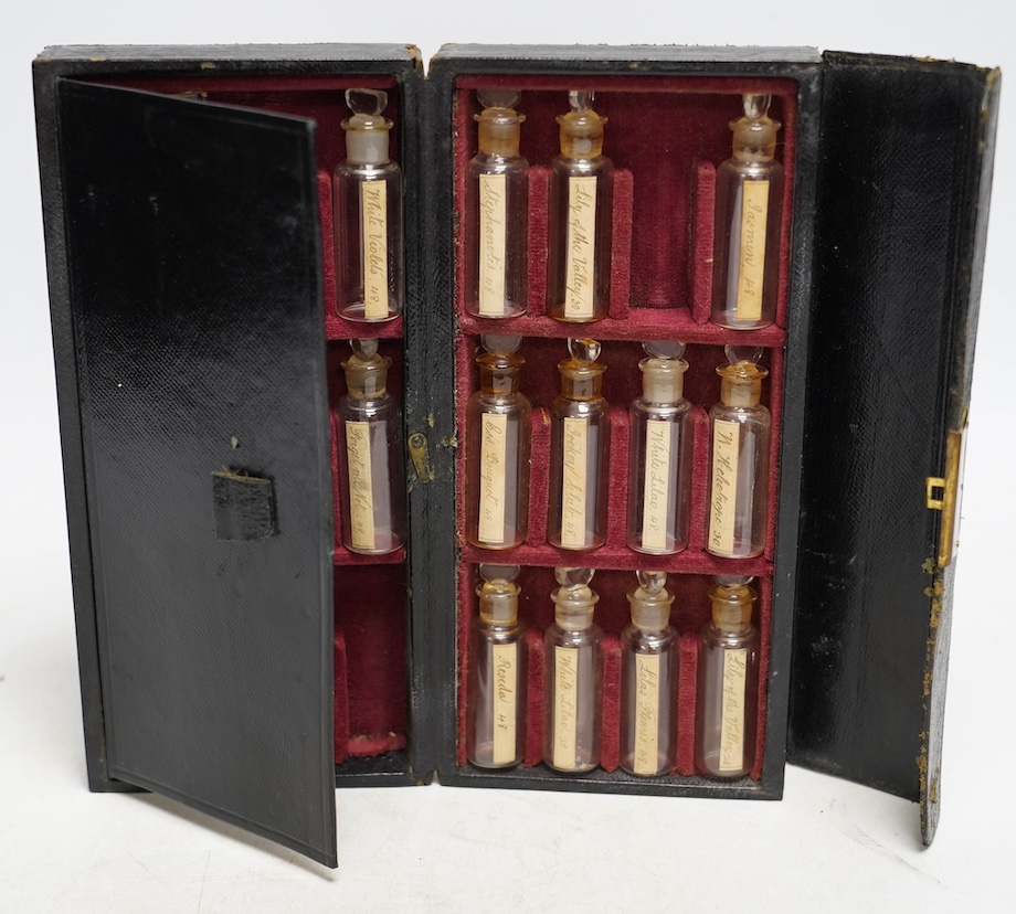 A late 19th century leather cased perfume or apothecary set by Lynch & Co., containing seventeen miniature bottles with old labels, (seven bottles missing), 20.5cm x 10cm x 4.5cm. Condition - fair